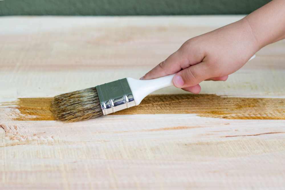 kid-hand-varnishing-a-wooden-shelf-using-paintbrush.jpg